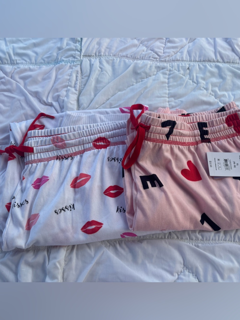 Two Women’s Pajama pants one with lips print other with LOVE.